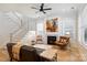 Bright living room with hardwood floors, fireplace, and staircase at 106 Orange St, Charlotte, NC 28205