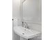 Elegant powder room with a stylish mirror, white sink, and tasteful design at 106 Orange St, Charlotte, NC 28205