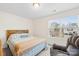 Cozy bedroom with natural light and a comfortable armchair, creating a relaxing and inviting atmosphere at 120 Gray Hawk Dr, Rockwell, NC 28138