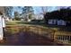 Large wooden back deck with railing overlooks the spacious backyard at 1206 Spring Dr, Shelby, NC 28150