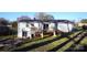 View of the back of a white brick home featuring a wooden deck and patio area at 1206 Spring Dr, Shelby, NC 28150