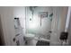 Bright bathroom featuring a stand up shower with tile surround, and modern fixtures at 1206 Spring Dr, Shelby, NC 28150