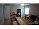 Bedroom features a comfortable bed, ample natural light, and a stylish full-length mirror at 1206 Spring Dr, Shelby, NC 28150
