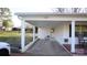 The home has a brick and white columned carport with a door leading into the home at 1206 Spring Dr, Shelby, NC 28150