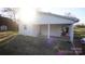 View of the home's exterior with a carport and manicured lawn in a sunny setting at 1206 Spring Dr, Shelby, NC 28150