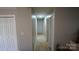 Hallway with hardwood floors and neutral paint offers access to multiple rooms at 1206 Spring Dr, Shelby, NC 28150