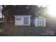 Two storage sheds in the backyard of the home with mature landscaping at 1206 Spring Dr, Shelby, NC 28150