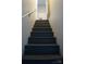 Gray painted staircase leading upstairs with white walls and metal railing at 1206 Spring Dr, Shelby, NC 28150