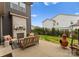 Backyard with a stone fireplace and cozy seating area, perfect for outdoor gatherings at 12202 Anne Blount Aly, Davidson, NC 28036
