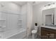 Bright bathroom with a tub and shower combination, a vanity with granite countertop, and a toilet at 12202 Anne Blount Aly, Davidson, NC 28036
