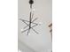Modern chandelier with spherical glass shades and black and silver accents, adding a touch of elegance to the home at 12202 Anne Blount Aly, Davidson, NC 28036