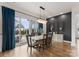 Elegant dining room with modern chandelier, hardwood floors, and sliding glass doors to the patio at 12202 Anne Blount Aly, Davidson, NC 28036