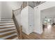 Bright foyer featuring hardwood floors, a staircase with iron railings, and a welcoming atmosphere at 12202 Anne Blount Aly, Davidson, NC 28036