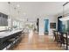 Open-concept kitchen featuring a large island with seating, stainless steel appliances, and access to the living and dining areas at 12202 Anne Blount Aly, Davidson, NC 28036
