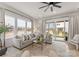 Bright living room with a large sectional sofa, glass coffee table, and sliding glass doors at 12202 Anne Blount Aly, Davidson, NC 28036