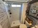 Nicely updated bathroom with a shower, decorative wall art, and storage at 134 Cardinal Ave, New London, NC 28127