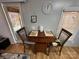 Cozy dining area with wooden chairs, a table with floral mats, and bright natural light at 134 Cardinal Ave, New London, NC 28127