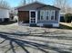 Charming home exterior with gray siding, a screened-in porch, and easy-to-maintain gravel at 134 Cardinal Ave, New London, NC 28127