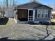 Exterior view of a home with a garage, screened-in porch, and well-kept gravel yard at 134 Cardinal Ave, New London, NC 28127