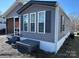 Home exterior showcasing gray siding, white trim, and a screened-in porch entrance at 134 Cardinal Ave, New London, NC 28127