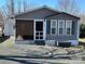Charming home featuring gray siding, a screened porch, and a small garden area at 134 Cardinal Ave, New London, NC 28127