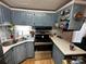 Kitchen featuring blue painted cabinets, stainless steel appliances, and white countertops at 134 Cardinal Ave, New London, NC 28127