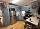 Well-equipped kitchen with painted blue cabinets, stainless steel appliances, and ample storage at 134 Cardinal Ave, New London, NC 28127