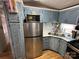 Kitchen with stainless steel refrigerator and painted blue cabinets providing ample storage at 134 Cardinal Ave, New London, NC 28127