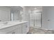 Bathroom with double sinks, a large mirror, and a glass-enclosed shower at 1346 37Th Avenue Ne Ln, Hickory, NC 28601