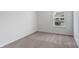A cozy bedroom with neutral carpeting and a bright window offering natural light at 1346 37Th Avenue Ne Ln, Hickory, NC 28601