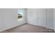 Cozy bedroom with neutral carpet, a window and a door at 1346 37Th Avenue Ne Ln, Hickory, NC 28601