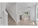 Bright entryway featuring stairs with carpeted treads and white risers, leading to an open-concept living space at 1346 37Th Avenue Ne Ln, Hickory, NC 28601