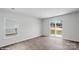 Bright living room featuring a sliding glass door, large windows, and luxury vinyl plank flooring at 1346 37Th Avenue Ne Ln, Hickory, NC 28601