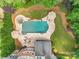 Aerial view of the private backyard oasis, with a pool, patio, and lush green landscaping at 14314 Lissadell Cir, Charlotte, NC 28277