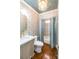 Stylized bathroom with marble countertop and ornate chandelier at 14314 Lissadell Cir, Charlotte, NC 28277