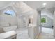 Bright bathroom featuring a soaking tub, walk-in glass shower, and tiled floor at 14314 Lissadell Cir, Charlotte, NC 28277