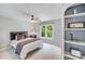 Bedroom featuring a window, ceiling fan, neutral walls, and built-in shelving at 14314 Lissadell Cir, Charlotte, NC 28277