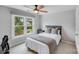 Bright bedroom with a window, a ceiling fan, and neutral walls at 14314 Lissadell Cir, Charlotte, NC 28277