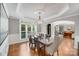 Open dining room with hardwood floors, modern lighting, and an adjacent living space at 14314 Lissadell Cir, Charlotte, NC 28277