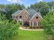 Beautiful two-story brick home with lush front lawn and mature landscaping at 14314 Lissadell Cir, Charlotte, NC 28277