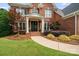 Inviting front porch with double doors, white columns, and meticulously maintained landscaping at 14314 Lissadell Cir, Charlotte, NC 28277