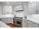 Gourmet kitchen boasts stainless steel appliances, white cabinetry, and a subway tile backsplash at 14314 Lissadell Cir, Charlotte, NC 28277