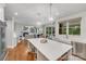 Beautiful kitchen with quartz countertops, a farmhouse sink, and views of the living room at 14314 Lissadell Cir, Charlotte, NC 28277