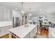 Modern kitchen with stainless steel appliances, quartz countertops, and an open layout at 14314 Lissadell Cir, Charlotte, NC 28277