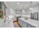 Bright kitchen features a large center island, stainless steel appliances, and modern pendant lighting at 14314 Lissadell Cir, Charlotte, NC 28277