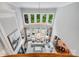 Living room with a fireplace and views of the pool and landscaped backyard through large windows at 14314 Lissadell Cir, Charlotte, NC 28277