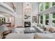 Bright and airy living room featuring a fireplace, chandelier, and second-floor staircase at 14314 Lissadell Cir, Charlotte, NC 28277