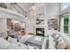 Living room with a fireplace, chandelier, and staircase to the second floor at 14314 Lissadell Cir, Charlotte, NC 28277