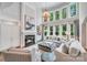 Elegant living room with soaring windows, a fireplace, and comfortable seating at 14314 Lissadell Cir, Charlotte, NC 28277