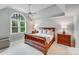 Spacious main bedroom with a tray ceiling, large window, and ample natural light at 14314 Lissadell Cir, Charlotte, NC 28277